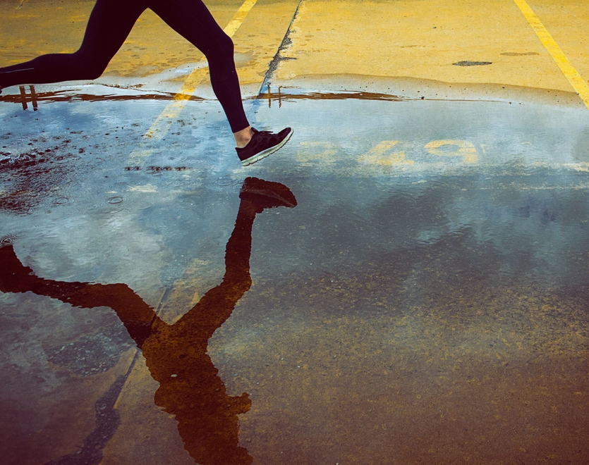 Person running through a puddle.